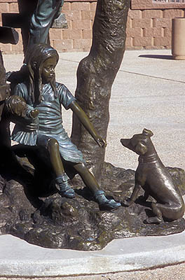 North Carolina: Northern Mountains Region, Ashe County, New River Valley, Jefferson, West Jefferson, A bronze statue of children playing, in front of the Jefferson Station urban redevelopment project; detail of girl with puppy [Ask for #260.306.]