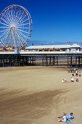 ENG: Manchester-Liverpool Urban Area, Blackpool Borough, The Golden Mile, Central Pier, People enjoy the low tide sands beneath the pier; Ferris wheel prominent [Ask for #262.026.]