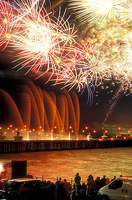 ENG: Manchester-Liverpool Urban Area, Blackpool Borough, Historic Town Center, North Pier, International Fireworks Competition at the Illuminations Festival; people crowd along the seawall as fireworks explode over the pier [Ask for #262.082.]