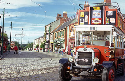 ENG: Northumbria Region, Durham, Beamish, The North of England Open Air Museum, The Town, Double decker motor bus waits on this restored High Street from 1913. [Note: possibly offense ad on upper bus deck, rt] [Ask for #262.302.]