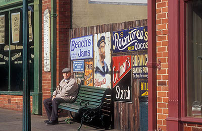 ENG: Northumbria Region, Durham, Beamish, The North of England Open Air Museum, The Town, High Street, restored to its 1913 appearance; old man sits on a bench [Ask for #262.306.]