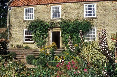 ENG: Northumbria Region, Durham, Beamish, The North of England Open Air Museum, Pockerley Manor, Garden, c 1825, in front of modest stone-built manor; fall blooms [Ask for #262.314.]