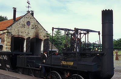 ENG: Northumbria Region, Durham, Beamish, The North of England Open Air Museum, Pockerley Waggonway, Stephenson's No. 2 engine, 1822, the predecessor of "The Rocket", newly built to the orig. design and in use. Repair barn in bkgd [Ask for #262.323.]