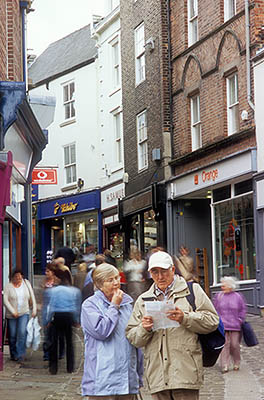 ENG: Northumbria Region, Durham, Durham Borough, Medieval Durham, Tourists consult a map on a busy cobblestoned market street, pedestrianized. [Ask for #262.354.]