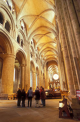 ENG: Northumbria Region, Durham, Durham Borough, Medieval Durham, Durham Cathedral. Interior; view eastward from the west end of the Nave, showing Norman columns and fan vaults; a small group of tourists, frgd [Ask for #262.370.]