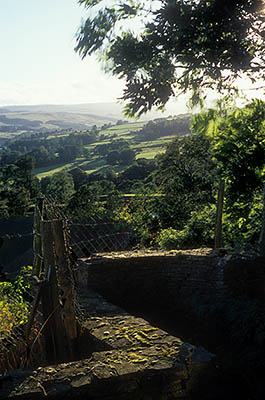 ENG: Northumbria Region, Durham, Stanhope, A stone wall lines a viewing platform in a cottage garden, giving a wide view over the Upper Wear Valley from the top of an abandoned strip mine [Ask for #262.387.]