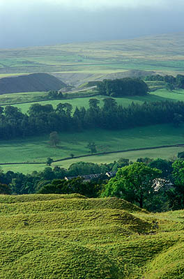 ENG: Northumbria Region, Durham, Stanhope, Wide view over the Upper Wear Valley shows an abandoned strip mine in the foreground and an active quarry in the background, with storm clouds over the Pennines [Ask for #262.391.]