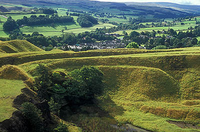 ENG: Northumbria Region, Durham, Stanhope, View over an abandoned strip mine to the village of Stanhope, with the farmland of the Upper Wear Valley beyond [Ask for #262.398.]