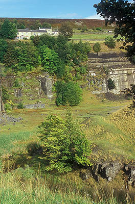 ENG: Northumbria Region, Durham, Stanhope, Miners' row houses perch on the high wall edge of an abandoned strip mine [Ask for #262.404.]