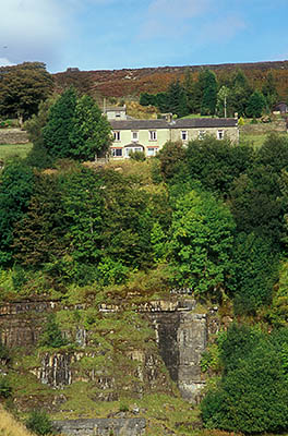 ENG: Northumbria Region, Durham, Stanhope, Miners' row houses perch on the high wall edge of an abandoned strip mine [Ask for #262.405.]