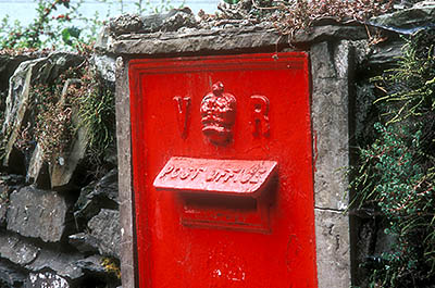 ENG: The Northwest Region, Cumbria, Lake District National Park, Windermere Area, Windermere Town, A red cast iron post box, set into a slate wall, is marked "VR" and dates from the reign of Queen Victoria [Ask for #262.418.]