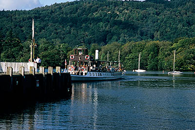 ENG: The Northwest Region, Cumbria, Lake District National Park, Windermere Area, Bowness-on-Windermere, Harbor on Lake Windermere; a steam powered excursion boat leaves the dock, with the Claife Heights in the bkgd [Ask for #262.481.]