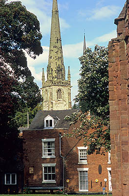 ENG: West Midlands Region, Shropshire, Shrewsbury and Atcham District, Shrewsbury, A church tower above brick houses in the residential section of the old town's river bend area [Ask for #262.552.]