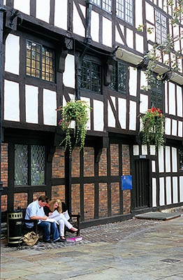 ENG: West Midlands Region, Shropshire, Shrewsbury and Atcham District, Shrewsbury, Rowley's House, a 15th c. merchant's house, now the Shropshire County Museum; students on bench doing homework [Ask for #262.568.]