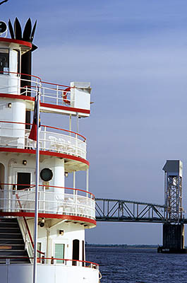 NC: New Hanover County, Cape Fear River Area, Wilmington, Riverfront, River Walk. Cape Fear Bridge viewed past an excursion river boat [Ask for #263.062.]