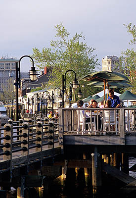 NC: New Hanover County, Cape Fear River Area, Wilmington, Riverfront, River Walk; people enjoy an evening stroll along the walk, at Chandlers Wharf. This is a crop from 263.007. [Ask for #263.07A.]