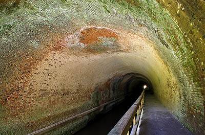 MD: Allegany County, Potomac River, The Chesapeake and Ohio Canal Nat Hist Park, Paw Paw Tunnel, Interior; the towpath, cantilevered over the water, forms a walking and bicycling path through the brick-lined tunnel [Ask for #269.078.]