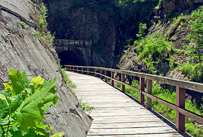 MD: Allegany County, Potomac River, The Chesapeake and Ohio Canal Nat Hist Park, Paw Paw Tunnel, Eastern portal of the tunnel opens into a deep cut into solid rock; the towpath is a boardwalk cantilevered over the canal. [Ask for #269.079.]