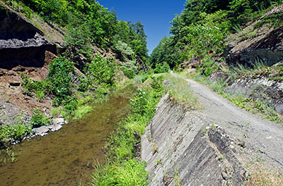 MD: Allegany County, Potomac River, The Chesapeake and Ohio Canal Nat Hist Park, Paw Paw Tunnel, The canal approaches the eastern portal of the tunnel in a deep cut through solid rock [Ask for #269.080.]