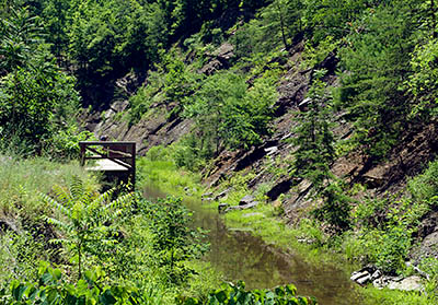 MD: Allegany County, Potomac River, The Chesapeake and Ohio Canal Nat Hist Park, Paw Paw Tunnel, Eastern portal of the tunnel opens into a deep cut into solid rock; the towpath is a boardwalk cantilevered over the canal. [Ask for #269.081.]