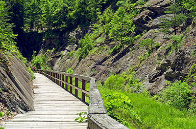 MD: Allegany County, Potomac River, The Chesapeake and Ohio Canal Nat Hist Park, Paw Paw Tunnel, Eastern portal of the tunnel opens into a deep cut into solid rock; the towpath is a boardwalk cantilevered over the canal. [Ask for #269.083.]