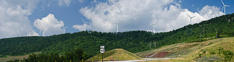 WV: Upper Potomac Region, Grant County, The Allegheny Front, Greenland Gap, US 48 Expressway (Corridor H), Windmill generators line the crest of the Allegheny Front as the US 48 freeway sweeps uphill towards it; panorama. [Ask for #269.110.]