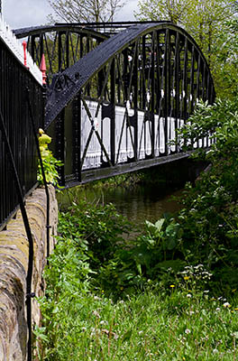 ENG: West Midlands Region, Staffordshire, The Trent Valley, Burton-on-Trent, Trent River, A Victorian iron arch pedestrian bridge crosses a backwater of the River Trent in the town center park along the Trent Washlands [Ask for #270.011.]