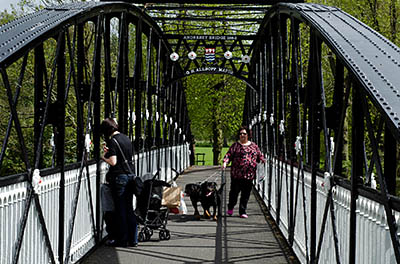 ENG: West Midlands Region, Staffordshire, The Trent Valley, Burton-on-Trent, Trent River, A Victorian iron arch pedestrian bridge crosses a backwater of the River Trent in the town center park along the Trent Washlands [Ask for #270.012.]