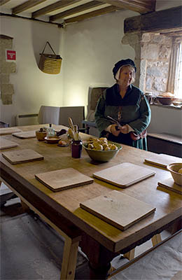 ENG: East Midlands Region, Leicestershire, Northwest Leicestershire, Coalville, Donnington le Heath Manor House, Furnished interior of 13th c. manor house; costumed interpreter at kitchen table [Ask for #270.049.]