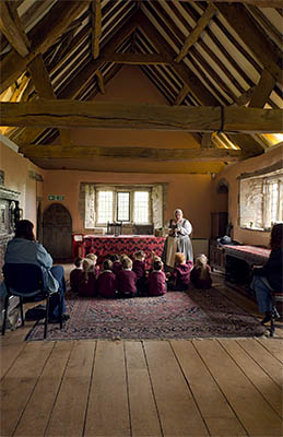 ENG: East Midlands Region, Leicestershire, Northwest Leicestershire, Coalville, Donnington le Heath Manor House, Furnished interior of 13th c. manor house; costumed interpreter with school children, in hall [Ask for #270.050.]