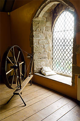 ENG: East Midlands Region, Leicestershire, Northwest Leicestershire, Coalville, Donnington le Heath Manor House, Furnished interior of 13th c. manor house; spinning wheel by stone arched window [Ask for #270.052.]