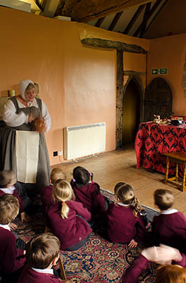 ENG: East Midlands Region, Leicestershire, Northwest Leicestershire, Coalville, Donnington le Heath Manor House, Furnished interior of 13th c. manor house; costumed interpreter with school children, in hall [Ask for #270.054.]