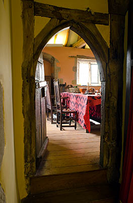 ENG: East Midlands Region, Leicestershire, Northwest Leicestershire, Coalville, Donnington le Heath Manor House, Furnished interior of 13th c. manor house; hall viewed through medieval arched door [Ask for #270.055.]