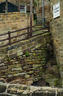 ENG: Yorkshire & Humberside Region, North Yorkshire, North Yorkshire Coast, Sea Cliffs, Robin Hood's Bay, Village lane climbs cliff, lined by stone walls and cottages [Ask for #270.066.]