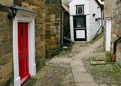 ENG: Yorkshire & Humberside Region, North Yorkshire, North Yorkshire Coast, Sea Cliffs, Robin Hood's Bay, Stone cottages, perched on cliff terrace, front on stone-paved foot-only lane [Ask for #270.076.]