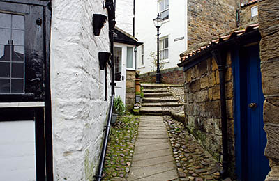 ENG: Yorkshire & Humberside Region, North Yorkshire, North Yorkshire Coast, Sea Cliffs, Robin Hood's Bay, Stone cottages, perched on cliff terrace, front on stone-paved foot-only lane [Ask for #270.077.]