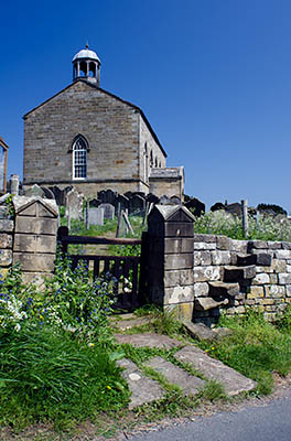 ENG: Yorkshire & Humberside Region, North Yorkshire, North Yorkshire Coast, Sea Cliffs, Robin Hood's Bay, Village church, sitting atop the cliff at the village's medieval site. [Ask for #270.133.]