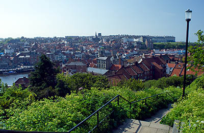 ENG: Yorkshire & Humberside Region, North Yorkshire, North Yorkshire Coast, Whitby, Abbey Steps, Paved footpath leads from top of steps down to harbor, between buildings and meadow; harbor view. [Ask for #270.151.]