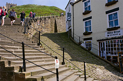 ENG: Yorkshire & Humberside Region, North Yorkshire, North Yorkshire Coast, Whitby, Abbey Steps, Steps leading to the abbey start at Church St., a historic, pedestrianized shopping lane; the Cleveland Way goes here. [Ask for #270.187.]