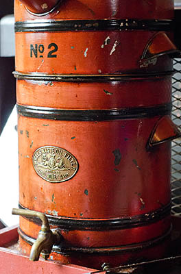 ENG: West Midlands Region, Staffordshire, The Trent Valley, Burton-on-Trent, Claymills Pumping Station, Workshop; oil-despensing urn, labeled "Wells' Waste Oil Filter, A Swell Money Saver" [Ask for #270.216.]