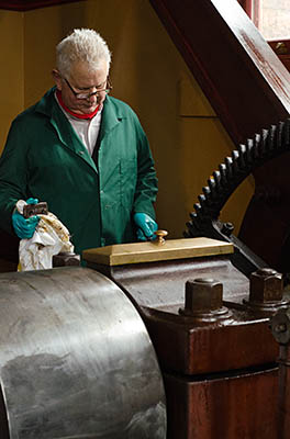 ENG: West Midlands Region, Staffordshire, The Trent Valley, Burton-on-Trent, Claymills Pumping Station, Terry Davis, a volunteer, readies a steam pumping engine for running. [Ask for #270.217.]