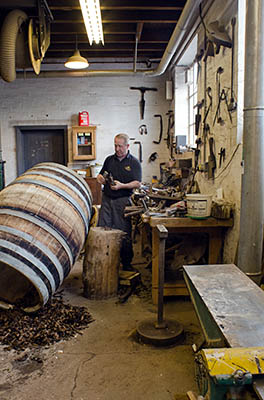 ENG: West Midlands Region, Staffordshire, The Trent Valley, Burton-on-Trent, Marstons Brewery, Shobnall, Mark Newton, Marston's cooper; workshop, as he scrapes the inside of a barrel. [Ask for #270.231.]