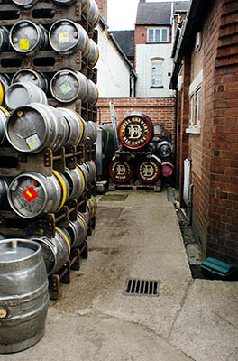 ENG: West Midlands Region, Staffordshire, The Trent Valley, Burton-on-Trent, Burton Bridge Brewery, Town Center, Casks and wooden barrels stacked behind the brewery, waiting to be shipped. [Ask for #270.238.]