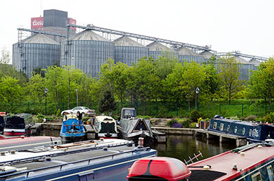 ENG: West Midlands Region, Staffordshire, The Trent Valley, Burton-on-Trent, The Trent and Mersey Canal, Industrial continuity; the canal port responsible for the Marstons and Bass brewery sites of the 1850s is still in use beneath the barley silos of Coors [Ask for #270.246.]