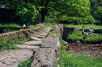 ENG: The Northwest Region, Lancashire, The Pennines, Pendle, Wycoller Country Park, Families play by pack horse bridge near ruinous18th c. Wycoller Hall, the model for Ferndean Manor in "Jane Eyre". The Bronte Way and Pennine Bridleway pass. [Ask for #270.307.]