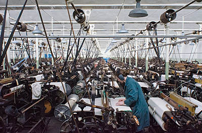 ENG: The Northwest Region, Lancashire, The Pennines, Burnley Borough, Briercliffe, Queen Street Mill, A docent runs a belt-powered loom on a fully functioning factory floor of this steam-powered Victorian textile plant [Ask for #270.394.]