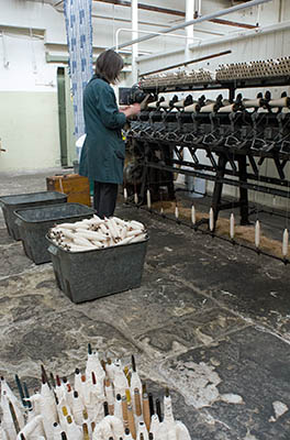 ENG: The Northwest Region, Lancashire, The Pennines, Burnley Borough, Briercliffe, Queen Street Mill, A docent loads a belt-driven spindle loader on the floor of this fully functional steam-powered Victorian textile plant [Ask for #270.395.]