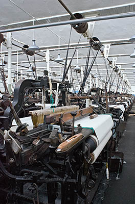 ENG: The Northwest Region, Lancashire, The Pennines, Burnley Borough, Briercliffe, Queen Street Mill, Belt-powered looms fill the factory floor of this fully functional steam powered Victorian textile plant [Ask for #270.396.]