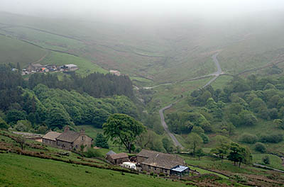 ENG: The Northwest Region, Lancashire, The Pennines, Pendle, Wycoller Moors, Lane climbs past isolated Pennine farmstead to open moors, in fog [Ask for #270.443.]