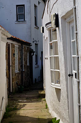 ENG: Yorkshire & Humberside Region, North Yorkshire, North Yorkshire Coast, Sea Cliffs, Runswick Bay, Old fishing village terraces up from the cliff foot; paths, not roads, serve these cottages [Ask for #270.473.]